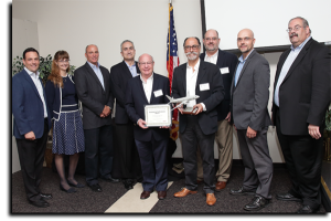 President David Pearson, CEO Nissen Isakov, COO Shmuel Yankelewitz, and Eastern Regional Sales Manager Dave Freeman accepting award for Excellence in Performance from BAE Systems top executives